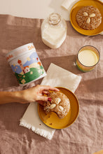 A hand reaching for a Leckerlee lebkuchen cookie