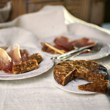 artibel fig cake sliced and served with prosciutto